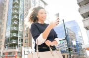 Lifestyle image of a woman checking her phone to guarantee her rental condominium. Image by Chicago photographer Alex Garcia