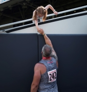 Department of Defense Warrior Games athlete Brant Ireland touches the hand of his daughter Mackenna, 7, after winning a gold medal during the Field Competition at Soldier Field.Chicago photojournalist Alex Garcia