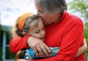 A candid moment of a girl as she hugs her grandmother in Dixon, Illinois.  Chicago photographer Alex Garcia