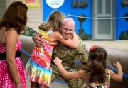 Army Sergeant Keith Howse surprises his children Jorja, 11, and Nataja, 6,  during a dolphin show at the Brookfield Zoo.Chicago photojournalist Alex Garcia