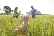 Farmer Josh Norris and wife Candi walk through a wheat field together with their 2-year-old daughter Preslee and 5-month-old daughter Tyleigh on their farm in Middletown, Indiana.     Chicago photographer Alex Garcia