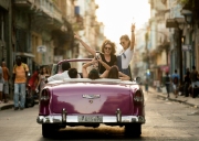 Tourists in Havana celebrate during a car ride in the city.  Chicago photographer Alex Garcia