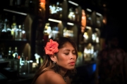 Brenda Eval wears an orchid decoration in her hair as she serves drinks at the Three Dots and a Dash tiki bar in downtown Chicago. Chicago photographer Alex Garcia