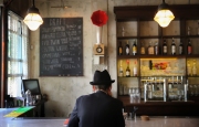 A man sits at the bar of rthe Lula Cafe in Chicago. Image by Chicago photographer Alex Garcia