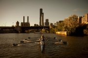 Action picture of women participating in a rowing exercise on a branch of the Chicago River. They are cancer survivors learning how to manage their recovery. Image by Chicago photographer Alex Garcia