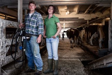 106-Male-Female-Dairy-Farmers-portrait-barn-with-cows-Rod-McLean