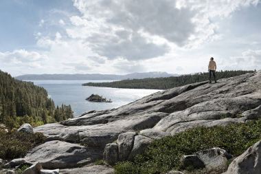 68-Man-standing-on-rocks-looking-at-mountains-and-lake