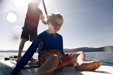 76-little-boy-sitting-on-a-paddle-board-in-lake-tahoe-Rod-Mclean