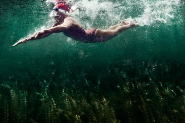 82-Athletic-lifestyle-female-swimming-red-suit-bluegreen-water-Rod-McLean