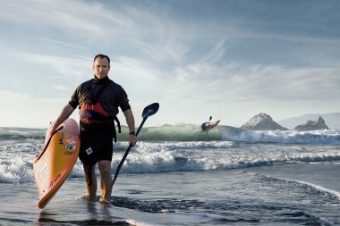 86-Athlete-Man-holding-a-kayak-and-paddle-at-the-beach-waves-Rod-McLean