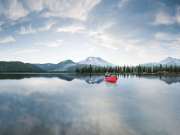 44_Active-Lifestyle-male-jimmy-chin-paddeling-a-canoe-on-a-lake-surrounded-by-mountains-Adventure-Photographer-Rod-McLean_gg