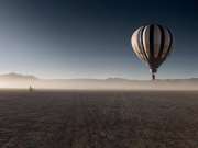 54_Landscape-hot-air-balloon-floating-over-the-desert-women-on-bike-with-mountins-Landscape-Photographer-Rod-McLean_GG